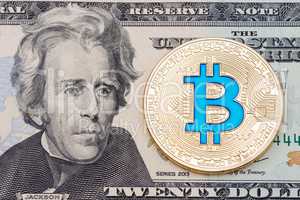 Golden cryptocurrency blue bitcoin on twenty dollar banknote bac