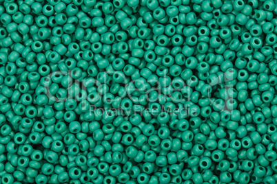 Background of shiny green glass beads.