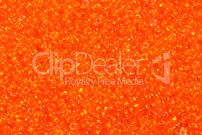 Close up photograph of yellow seed beads background.