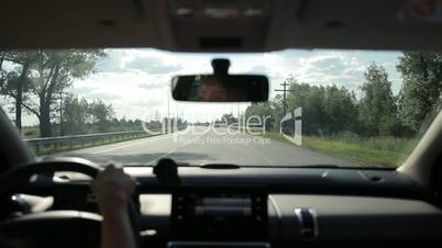 Woman driving car on the motorway in summer