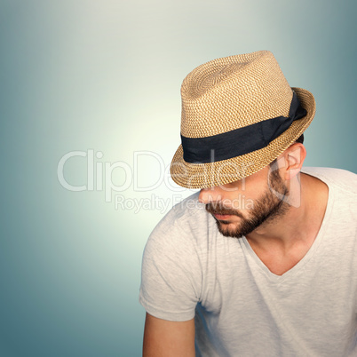 Composite image of handsome man wearing hat