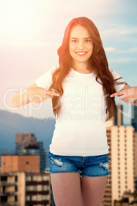 Composite image of portrait of smiling woman pointing at self