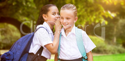 Composite image of portrait of girl whispering in friend ear