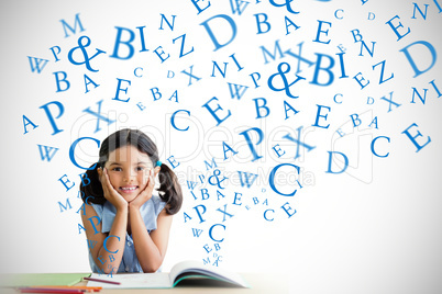 Composite image of portrait of girl doing homework at desk