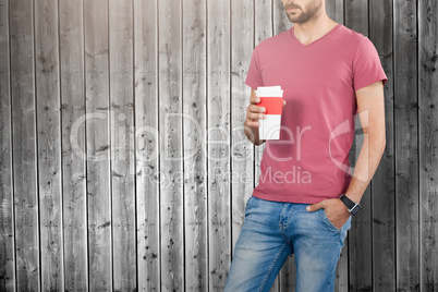 Composite image of midsection of male model holding disposable cup