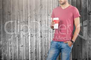 Composite image of midsection of male model holding disposable cup