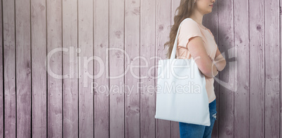 Composite image of women holding bag with blank space