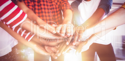 Mid section of business people stacking hands
