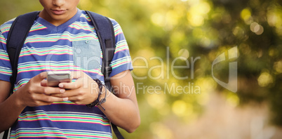 Schoolboy using mobile phone in campus