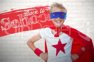 Composite image of portrait image of cheerful superhero boy