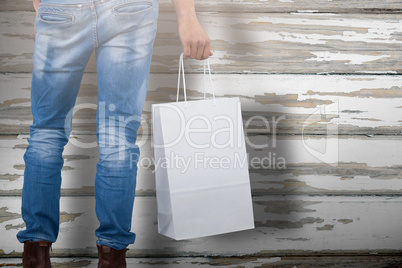 Composite image of mid section of man carrying bag