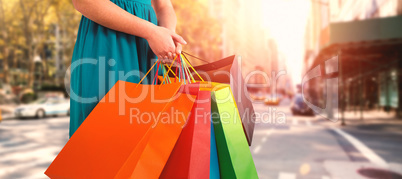 Composite image of women holding shopping bag