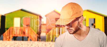 Composite image of model wearing cap and sunglasses