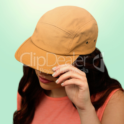Composite image of woman with long hair wearing brown cap
