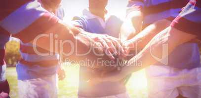 Rugby team stacking hands