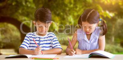 Composite image of children writing on books at table