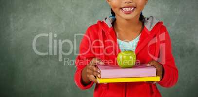 Young girl holding apple and books