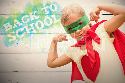 Composite image of portrait of girl in red cape showing muscles