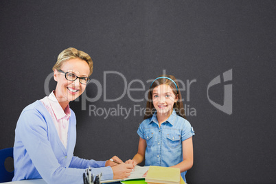 Composite image of portrait of teacher with student writing on book