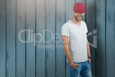 Composite image of handsome man wearing hat