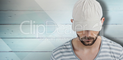 Composite image of handsome man wearing hat