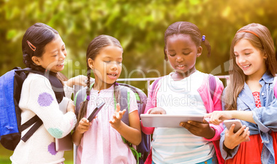 Composite image of girl with friends using digital tablet