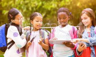 Composite image of girl with friends using digital tablet