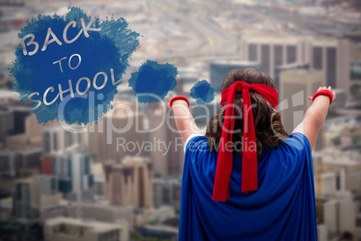 Composite image of rear view boy with arms raised