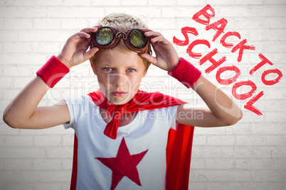 Composite image of little boy pretending to be superhero