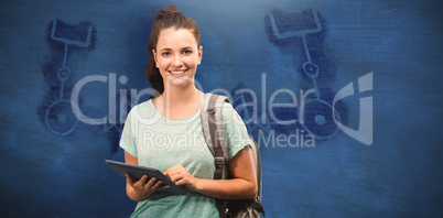 Composite image of happy student using tablet