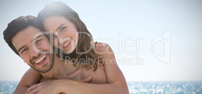 Composite image of happy couple hugging