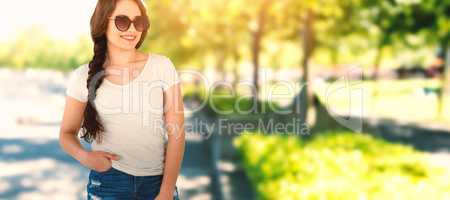 Composite image of smiling beautiful model standing with hands in pockets