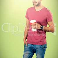 Composite image of midsection of smiling model holding disposable coffee cup