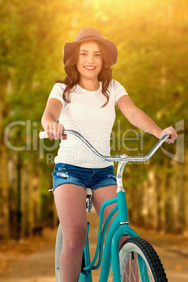 Composite image of portrait of smiling cycling woman