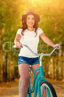 Composite image of portrait of smiling cycling woman