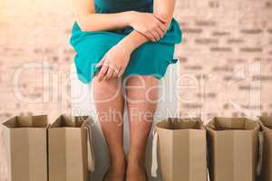 Composite image of women sitting next to bags