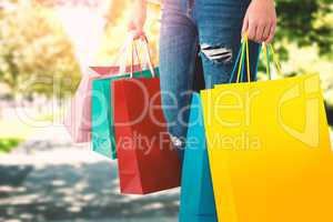 Composite image of women holding bag with blank space