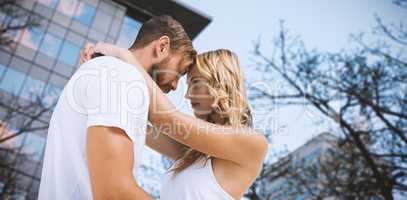 Composite image of couple cuddling against white background