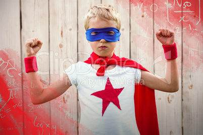 Composite image of portrait of superhero boy with arms raised