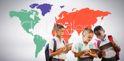 Composite image of students in uniforms using digital tablets