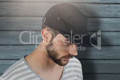 Composite image of handsome man wearing hat