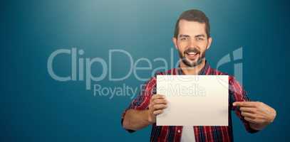 Composite image of portrait of young man pointing towards cardboard against white background