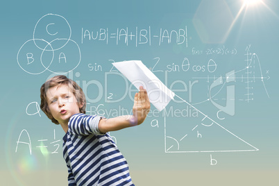 Composite image of playful boy holding paper airplane