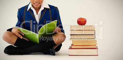 Schoolboy studying against white background
