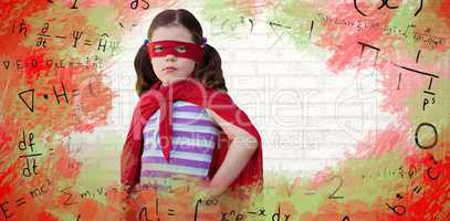 Composite image of portrait of girl standing in superhero costume