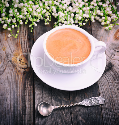 Cup of coffee and an iron spoon