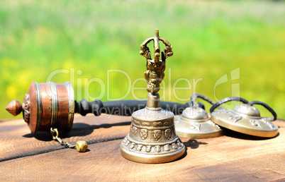 copper bell with Tibetan religious objects, close up