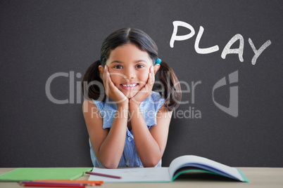 Composite image of portrait of girl doing homework at desk