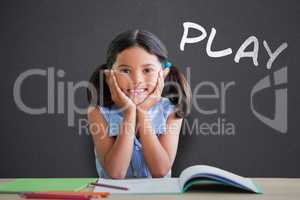 Composite image of portrait of girl doing homework at desk