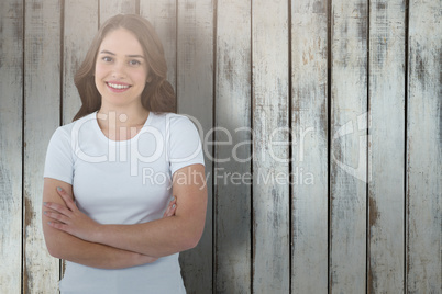 Composite image of portrait of confident model standing with arms crossed